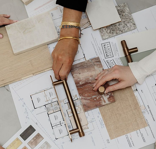 Design team organising inspiration over plans