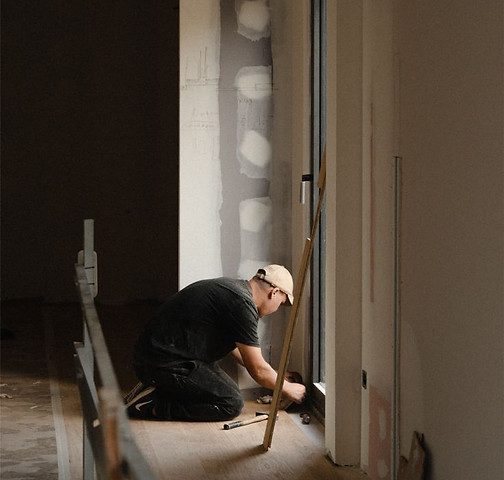 Trade worker plastering on site