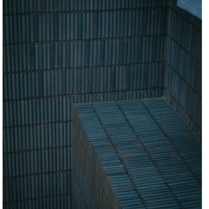 Dark textured architectural corner with patterned surfaces.